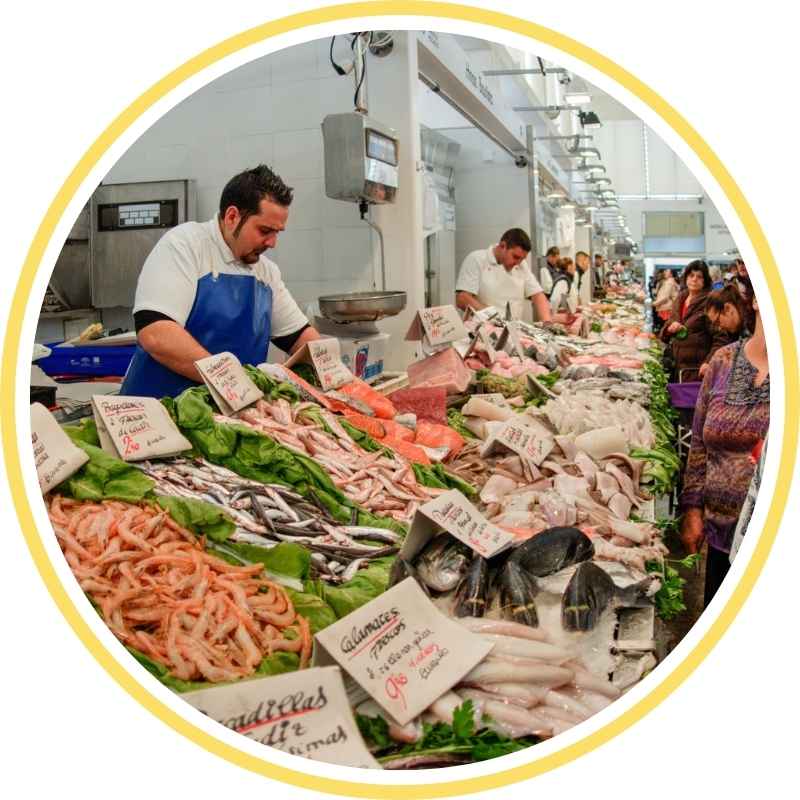 Local fishmonger at Cádiz Central Market serving fresh seafood – final stop on the express walking tour for cruise passengers.