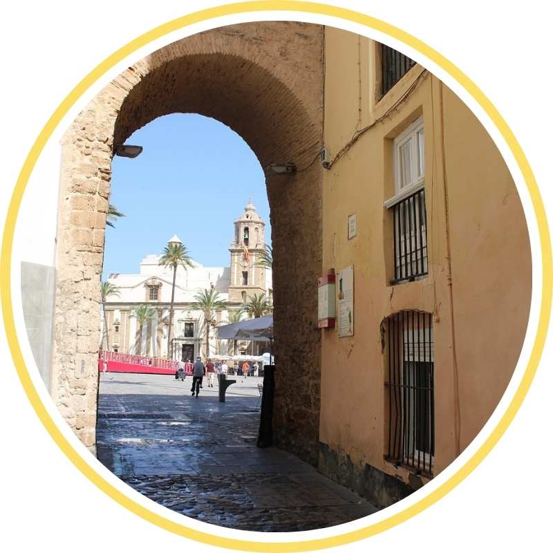 Historic stone arch of El Pópulo in Cádiz, leading to the Roman Theatre and medieval streets – part of the express walking tour for cruise passengers.